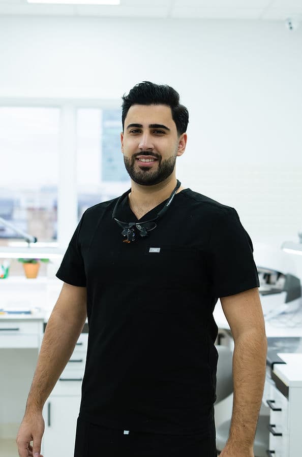 Yuriy, master dental technician, wearing loupes in the in-house dental laboratory