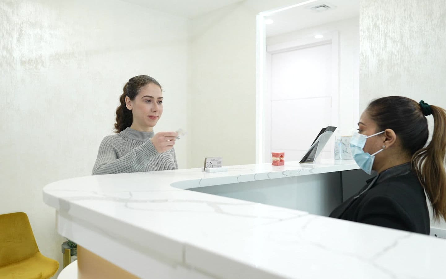 A dentist at work in a treatment room at Dream Smile Dental
